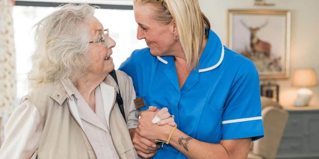 A resident at Country Lodge talking to a nurse