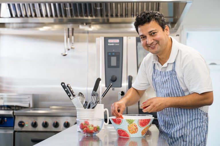 Chef in Country Lodge Kitchen smiling to camera