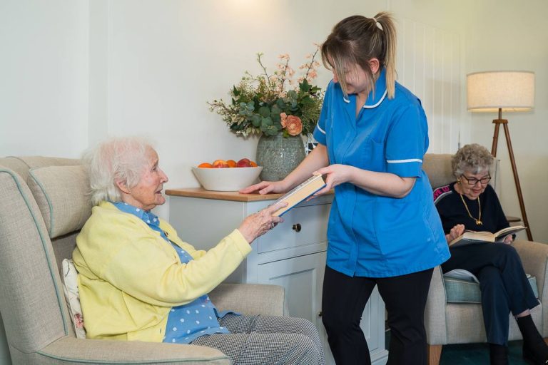 Nurse handing over book to post-operative respite care resident